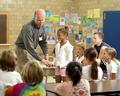 Mike Hoenig demonstrates Braille to school kids